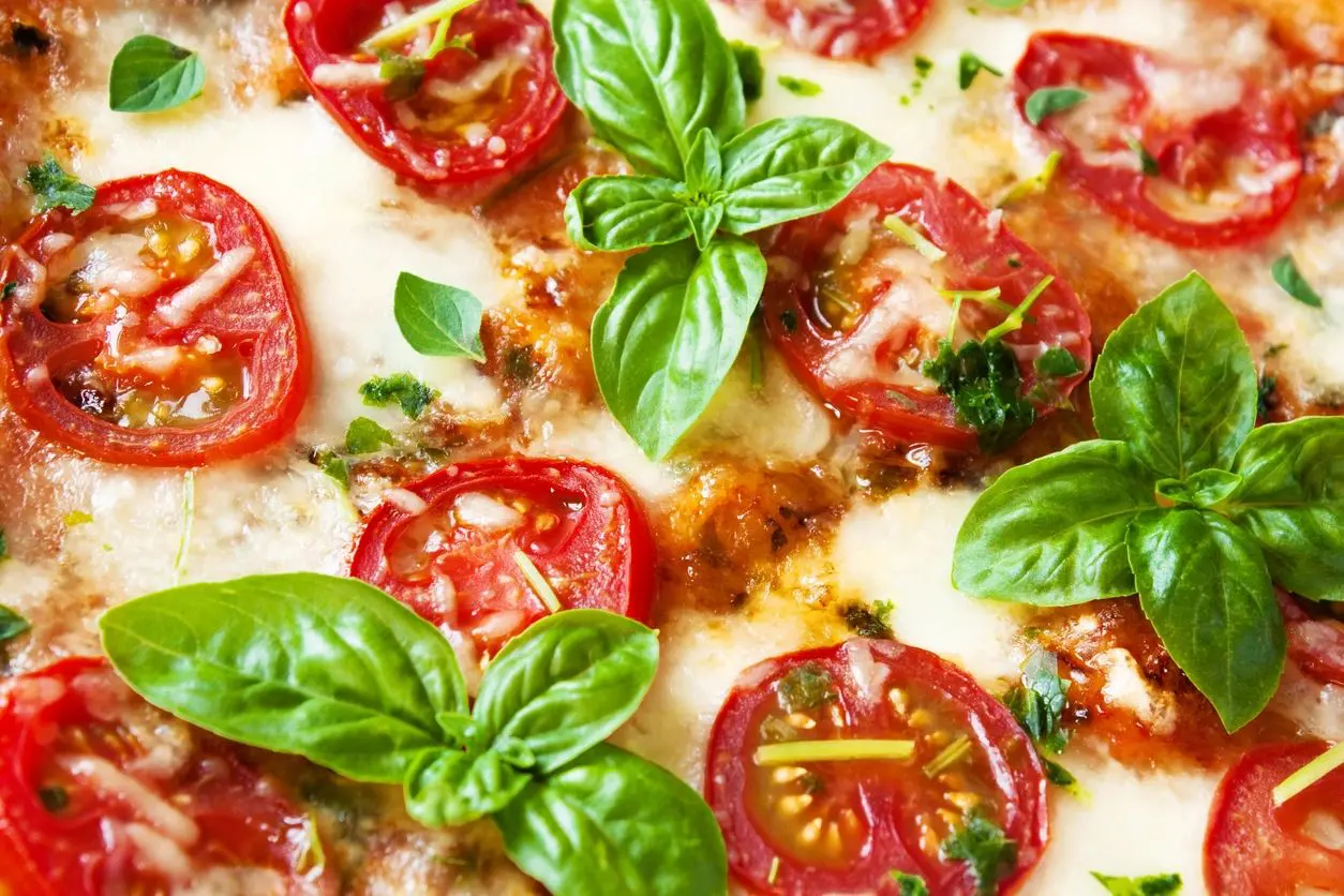 A close up of some tomatoes and basil