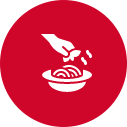 A stylized white icon of a hand pouring liquid onto a plate of food, set against a red circular background.