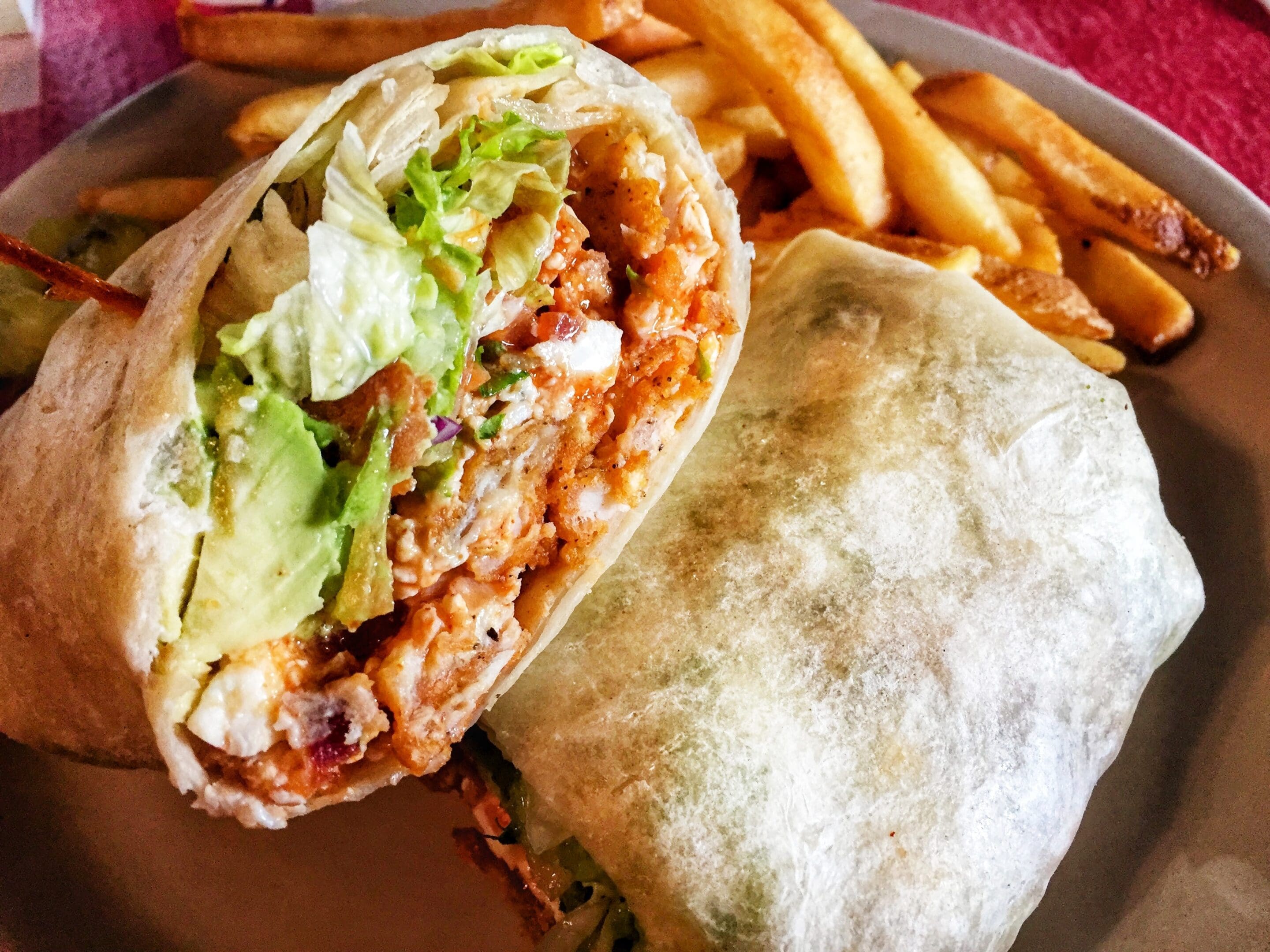 Chicken burrito with fries on plate