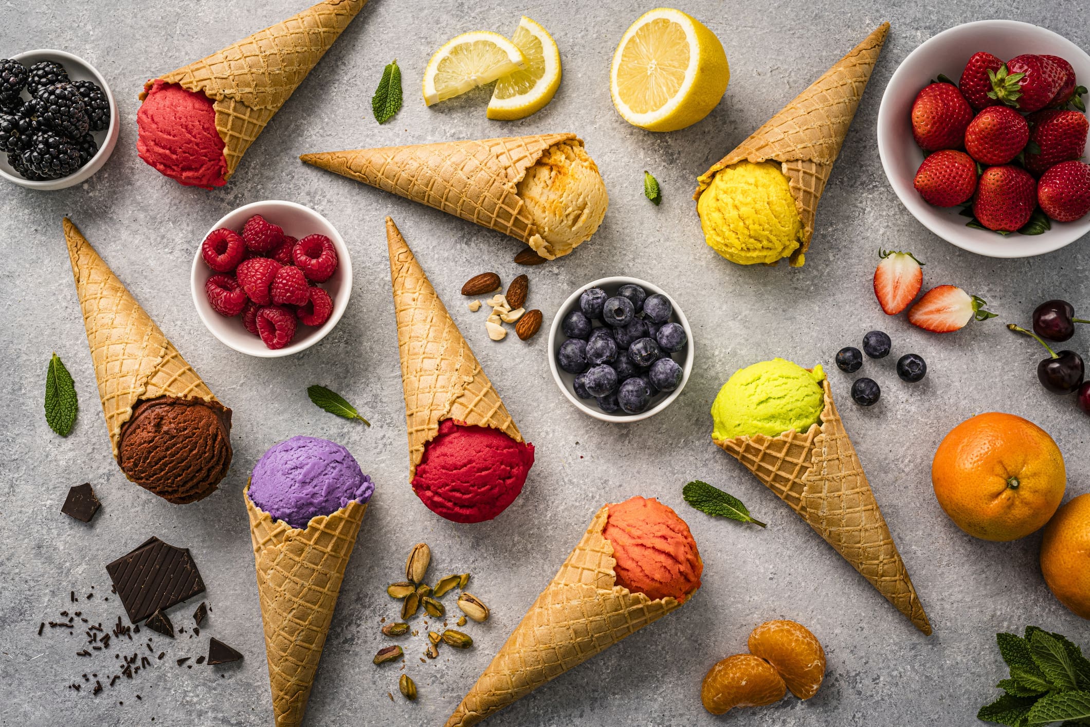 Colorful ice cream cones with berries and citrus