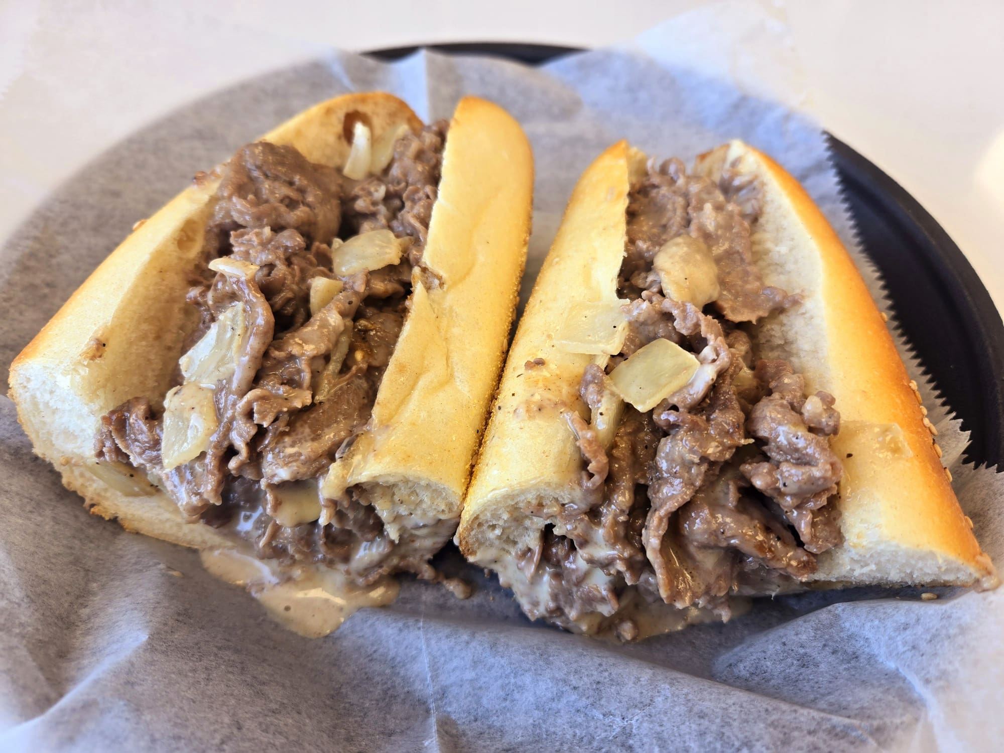 Philly cheesesteak sandwich with onions and cheese