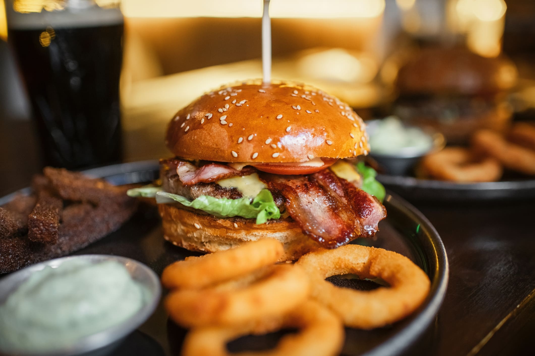 Bacon cheeseburger with onion rings and dip