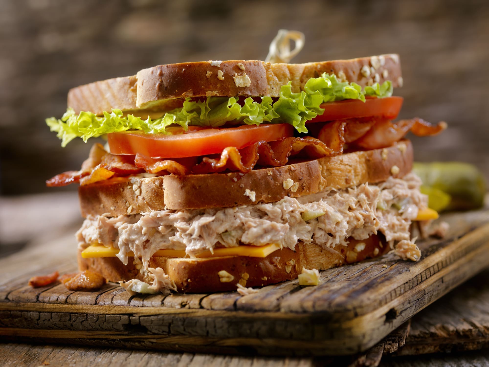 Triple-decker tuna and bacon sandwich on multigrain bread
